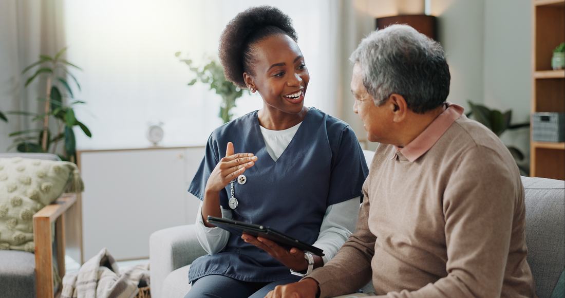 A uniformed caregiver reviewing a plan of care with a client