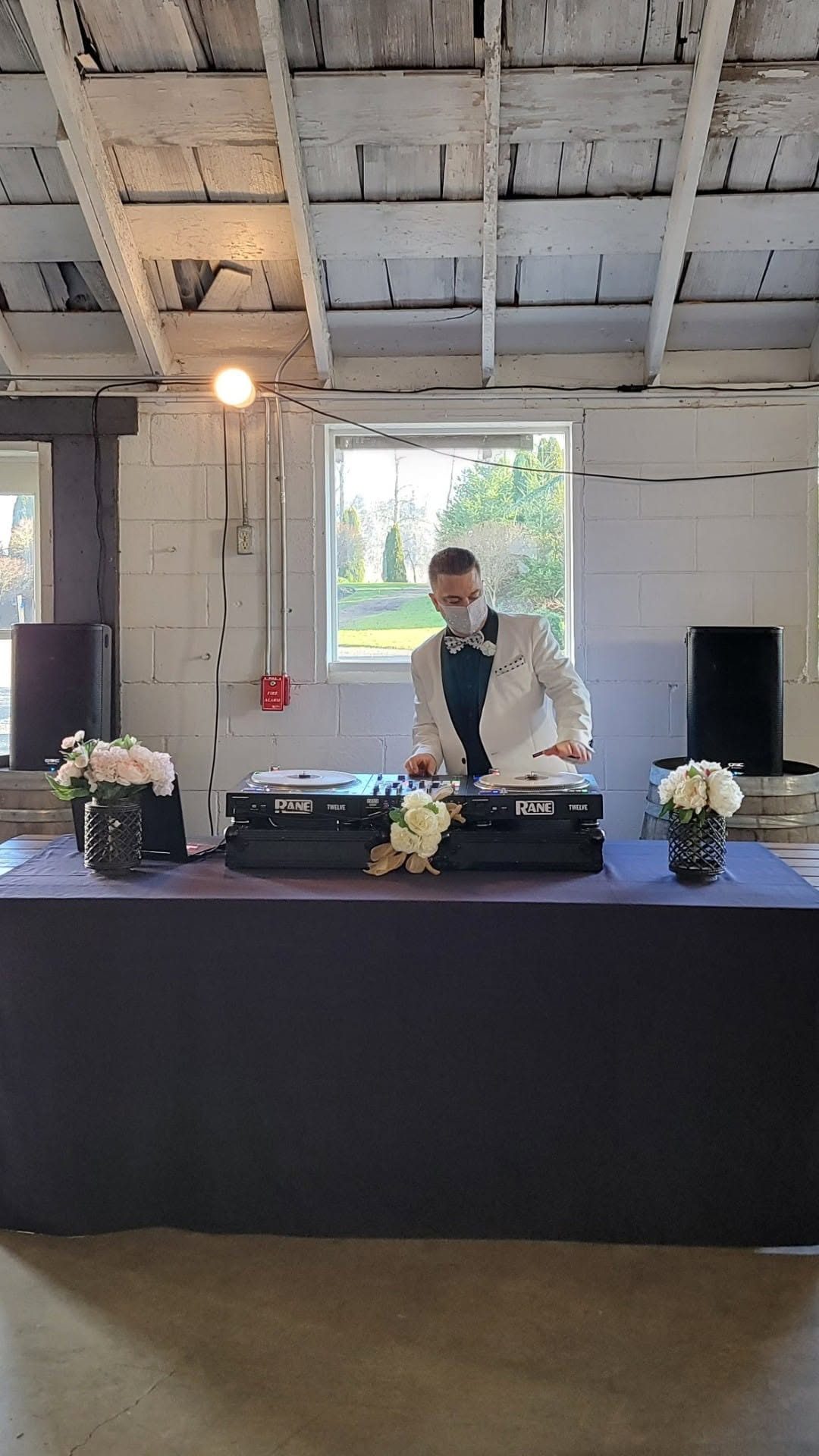 DJ Sugar mixing at an indoor event
